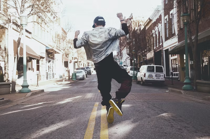 happy man jumping in the city