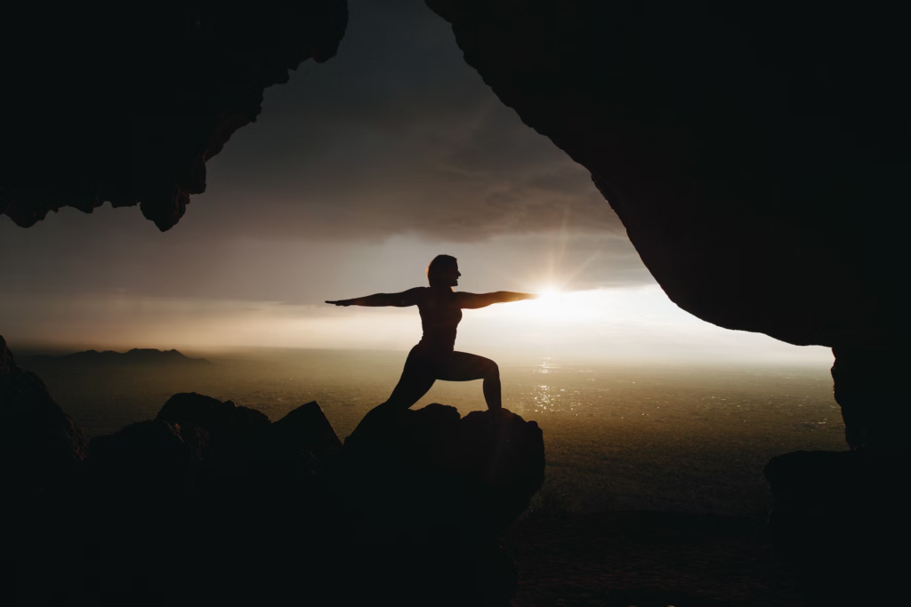 woman doing yoga on a mountain